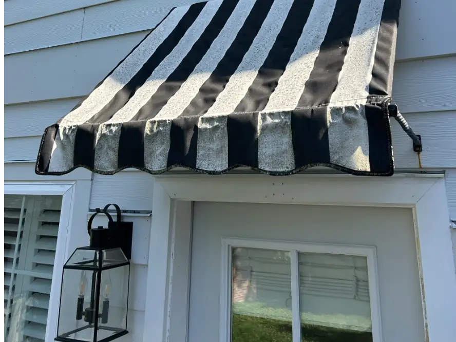 Striped canvas awning weathered and dirty before cleaning