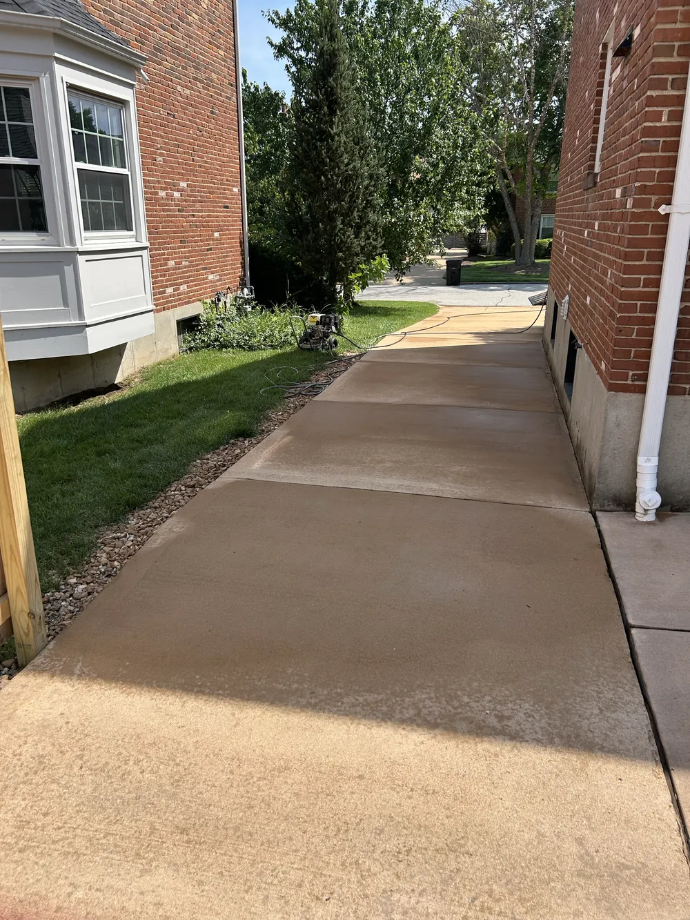 Clean concrete driveway after pressure washing