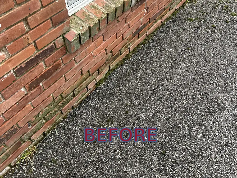 Brick wall stained with grime before power washing in St. Louis