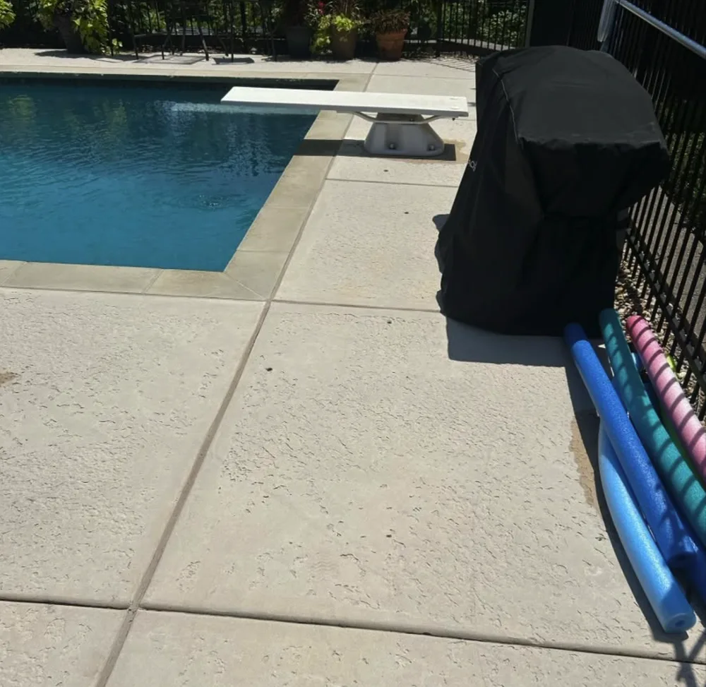 The same stamped pool deck clean and light after washing by Prime Power Wash