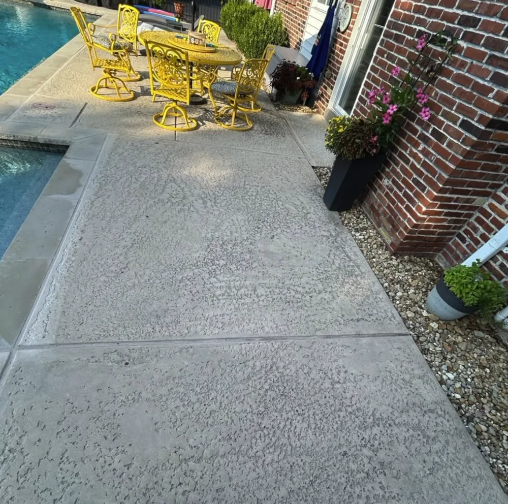 Stamped concrete pool deck with grime settled into the texture before cleaning